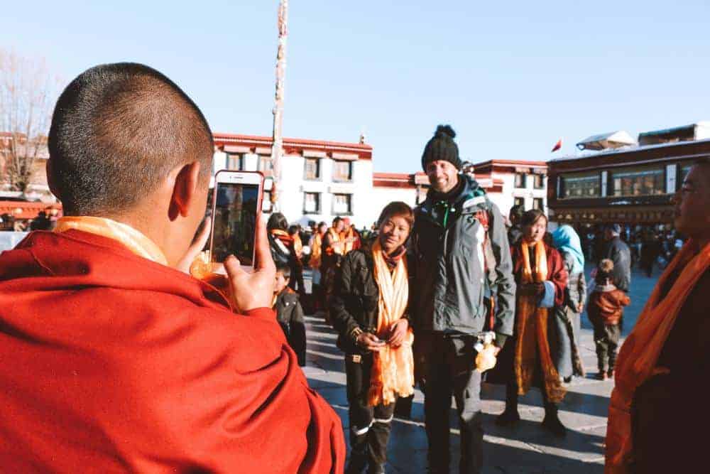 People in Tibet taking pictures with my husband